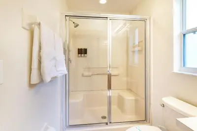 a bathroom with a shower with a glass door at VR Jungle 2 Jungle with Disney's Tarzan and MORE in Kissimmee