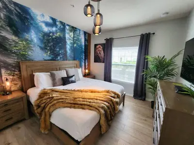 a bedroom with a large bed with a fur blanket at Tropical Getaway with Xbox & PS5 Gaming Paradise in Kissimmee