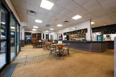 a restaurant with tables and chairs and a counter at Studio Close to Universal Intl Drive in Orlando