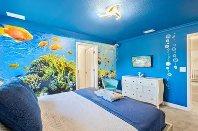 a blue bedroom with an aquarium themed wall at 4327 Create Memories in a Magical 5BD Home in Kissimmee
