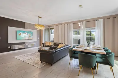 a living room with a couch and a table at 4327 Create Memories in a Magical 5BD Home in Kissimmee