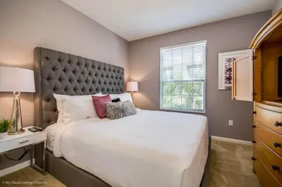 a bedroom with a large bed and a window at Cozy Vista Cay Condo right next to Clubhouse in Orlando