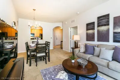 a living room and kitchen with a couch and a table at Cozy Vista Cay Condo right next to Clubhouse in Orlando