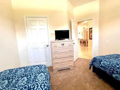 a bedroom with a tv on top of a dresser at Windsor Palm Resort 3 miles to Disney 4 Bedrooms in Kissimmee