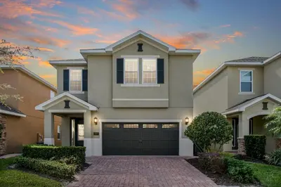 a house with a driveway and a garage at Fairytale Retreat in Orlando