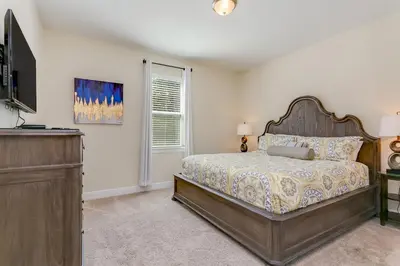 a bedroom with a large bed and a window at Fairytale Retreat in Orlando