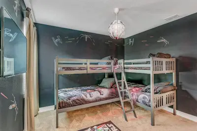 a bedroom with two bunk beds in a room at Fairytale Retreat in Orlando