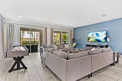 a living room with a couch and a pool table at Magic Manor in Orlando