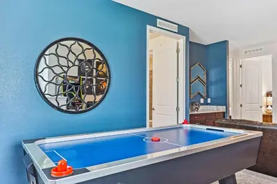 a blue room with a pool table in it at Magic Manor in Orlando