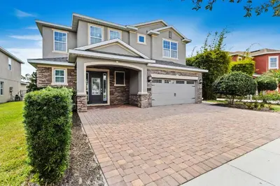 a large house with a brick driveway at Magic Manor in Orlando