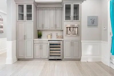 a kitchen with white cabinets and a stove top oven at LUXURY 6000 sqft Mansion in Downtown Orlando Sleeps 12 in Orlando