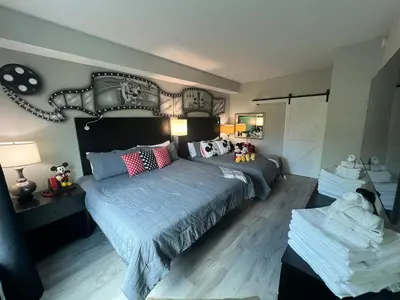a bedroom with a large bed with pillows at DisneyShuttleKing & Queen Be 5 minutes to Disney in Orlando