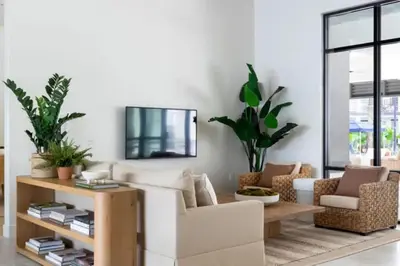 a living room with a white couch and chairs at The Edge at Millenia in Orlando