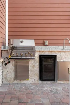 a outdoor grill with a oven next to a house at 5-Suite Disney Escape: Minutes from the Magic in Orlando
