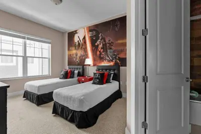 a bedroom with two beds and a painting on the wall at 5-Suite Disney Escape: Minutes from the Magic in Orlando