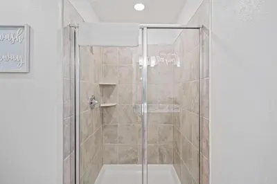 a shower with a glass door in a bathroom at 3191 Paradox Circle 202 in Kissimmee