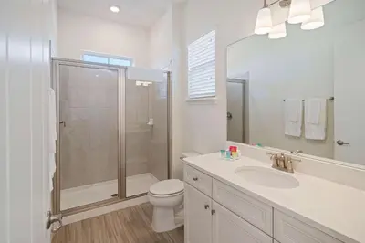 a bathroom with a shower and a toilet and a sink at 3050 Pirate Way in Orlando