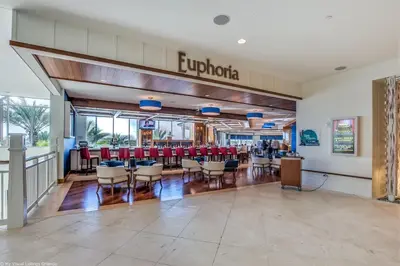 a restaurant with red chairs and tables in a building at 3050 Pirate Way in Orlando