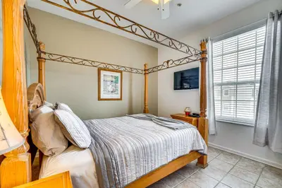 a bedroom with a canopy bed and a window at 6 Mi to Disney Kissimmee Resort Vacation Rental! in Kissimmee