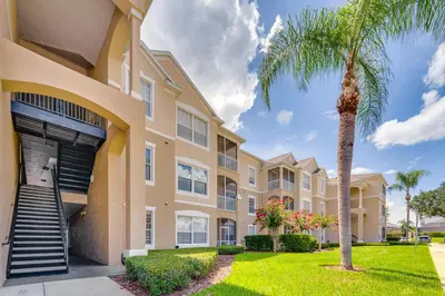 a palm tree in front of a building at 6 Mi to Disney Kissimmee Resort Vacation Rental! in Kissimmee