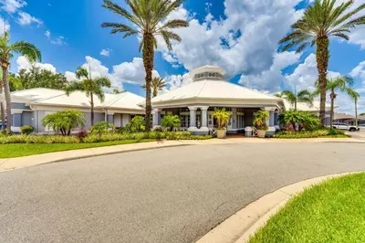 a house with palm trees in front of a road at 6 Mi to Disney Kissimmee Resort Vacation Rental! in Kissimmee