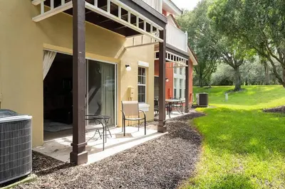 a patio of a house with a table and chairs at Harry Potter Themed 3 BR - ER2782 in Kissimmee