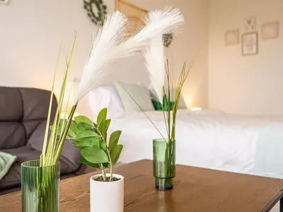 three green vases sitting on a table with plants at Modern Orlando 1BR Home & minutes to Disney in Kissimmee