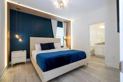 a bedroom with a bed with a blue blanket at Sea World neighbor Deluxe Home Up to 33 ppl 5800 in Orlando