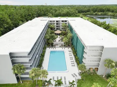 an aerial view of a building with a swimming pool at Orlando 1BR Condo with lake view & minutes to Disney in Kissimmee