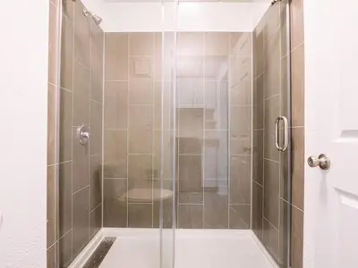 a shower with a glass door in a bathroom at Orlando 1BR Condo with lake view & minutes to Disney in Kissimmee