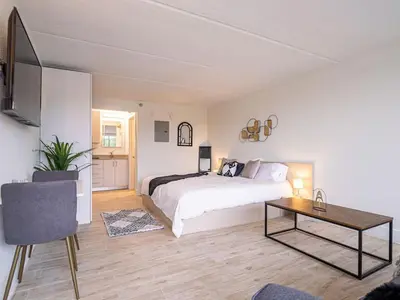 a bedroom with a bed and a table in it at Orlando 1BR Condo with lake view & minutes to Disney in Kissimmee
