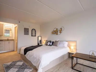a bedroom with a large white bed and a table at Orlando 1BR Condo with lake view & minutes to Disney in Kissimmee