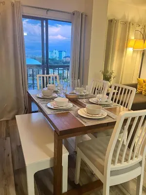 a dining room table with chairs and a view of the city at Renovated and cozy apartment near universal in Orlando