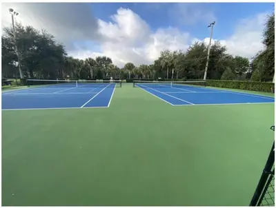 a tennis court with two tennis courts at Beautiful 3 bed townhome in Windsor Hills Resort townhouse in Orlando