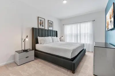 a bedroom with a large bed and a window at Brand New 5BedroomsPool LED At Paradiso Grande in Orlando