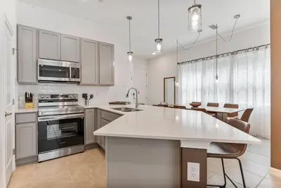 a kitchen with white cabinets and a white counter top at Brand New 5BedroomsPool LED At Paradiso Grande in Orlando
