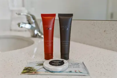 two tubes of makeup products sitting on a bathroom counter at Cozy New 5Bedrooms At Paradiso Grande in Orlando