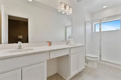 a white bathroom with a sink and a toilet at Cozy New 5Bedrooms At Paradiso Grande in Orlando
