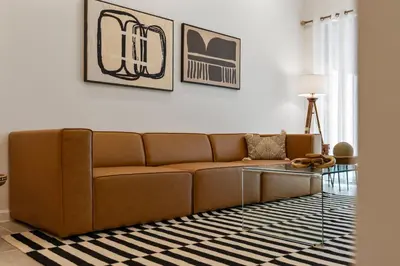 a living room with a brown couch and a glass table at Cozy New 5Bedrooms At Paradiso Grande in Orlando