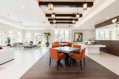 a living room with a table and chairs at 2024 Coastal Villa 3 suites near Disney in Orlando