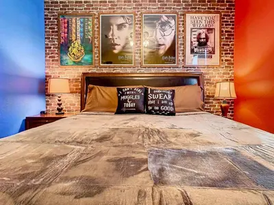 a bedroom with a bed with posters on a brick wall at C2784-102 Themed Room Free Resort Water Park 3 miles to Disney in Orlando