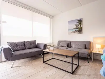 a living room with two couches and a coffee table at Orlando 1BR comfort With Lake view minutes to Disney Parks in Kissimmee