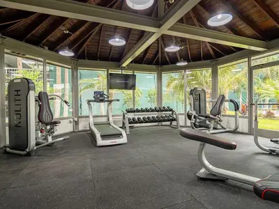 a gym with several exercise bikes in a room with windows at Orlando 1BR comfort With Lake view minutes to Disney Parks in Kissimmee