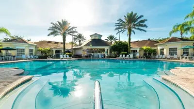a swimming pool at a resort with palm trees at 2304 Silver Palms #205 in Kissimmee