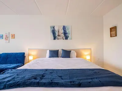a bedroom with a large bed with blue pillows at Orlando Paradise 1BR With view & minutes to Disney in Kissimmee