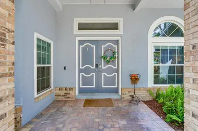 a front door of a house with a blue door at Screened Lanai and Fenced Yard Luxe Orlando Home in Orlando