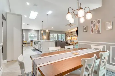 a dining room and kitchen with a table and chairs at Screened Lanai and Fenced Yard Luxe Orlando Home in Orlando