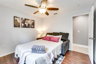 a bedroom with a bed and a ceiling fan at Screened Lanai and Fenced Yard Luxe Orlando Home in Orlando