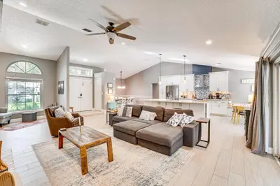 a living room with a couch and a table at Screened Lanai and Fenced Yard Luxe Orlando Home in Orlando