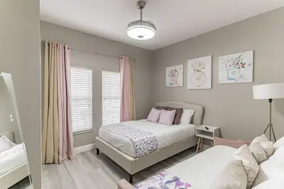 a bedroom with two beds and a window at Modern 4 BR Townhouse near Disney in Kissimmee